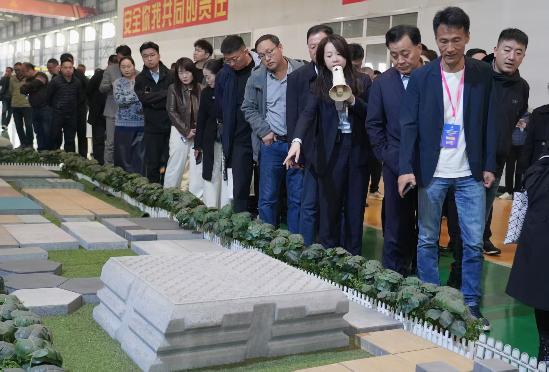 পিসি ব্লক শিল্প প্রতিনিধি দল স্বয়ংক্রিয় ড্রাই-কাস্ট উত্পাদন লাইন রোডবেড ব্লকগুলি পর্যবেক্ষণ করছে